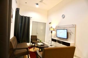 a living room with a couch and a television at Homestay Az Zikri D' Sepat in Kuantan
