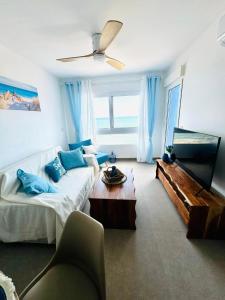 a living room with a couch and a ceiling fan at Encanto del Mar La manga, Sea View in San Blas