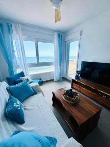 a bedroom with a bed with a table and a television at Encanto del Mar La manga, Sea View in San Blas