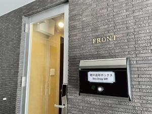 a sign on the side of a brick building at Infinity Hotel NahaKumoji -SEVEN Hotels and Resorts- in Naha