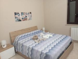 a bedroom with a bed with stuffed animals on it at Casa vacanza Marta in Torrenova