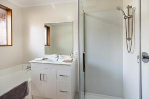 a bathroom with a sink and a shower at Convenient Westfield House 3bedroom 2bath in Christchurch +23 photos