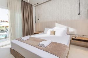 a hotel room with two beds with towels on them at Nikiforos Village in Hanioti