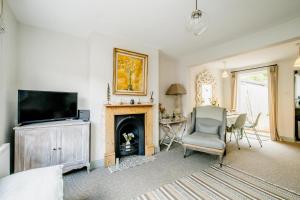 a living room with a television and a fireplace at Wigeon Cottage, Aldeburgh - Sleeps 4 - Adults only house in Aldeburgh
