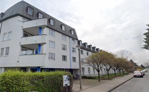 a white building on the side of a street at Ferienwohnung Tiny-Klotzsche in Dresden