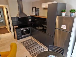 a kitchen with a stainless steel refrigerator and a stove at Apartament Els Ducs in Cardona