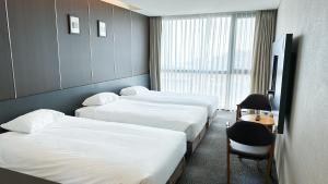 Postel nebo postele na pokoji v ubytování Golden Daisy Hotel