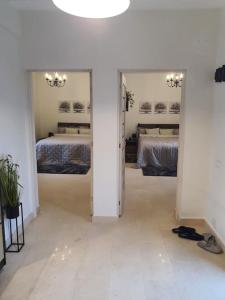 a large white room with two beds in it at Casa cu flori in Pantelimon