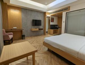 a hotel room with a bed and a tv at Comfort Inn in Lucknow