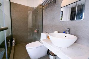 a bathroom with a white sink and a toilet at Melia Homestay Hue in Thôn Kim Long (1) +12 photos