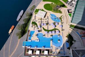 an aerial view of a resort with a swimming pool at InterContinental Dubai Festival City, an IHG Hotel in Dubai