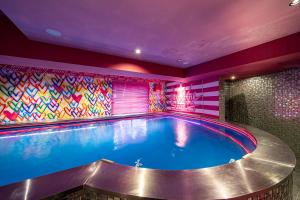 a swimming pool in a room with a colorful wall at Towers Hotel - Adult Only - in Osaka