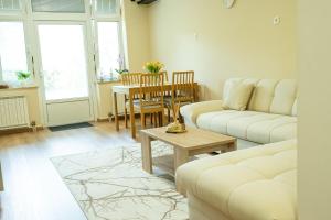 a living room with a couch and a table at Apartma Alina in Lucija