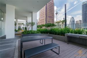 a balcony with benches and a view of the city at Quill City Residences KLCC, Five Senses in Kuala Lumpur