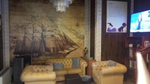 a living room with two couches and a painting on the wall at sleep well hotel total 2 stelle in Pisogne