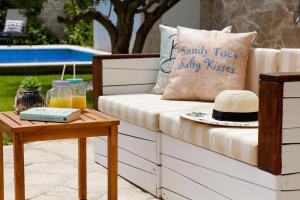 a bench with a hat on it next to a table at Villa Sania in Bol