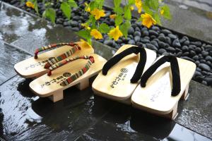 two wooden shoes sitting on top of a table at Ryokan Tamura in Kusatsu
