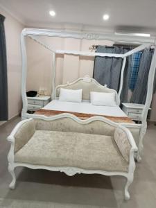 a bedroom with a white bed with a white canopy at 6BHK AC Home for families in Prime Loc Hyderabad in Hyderabad