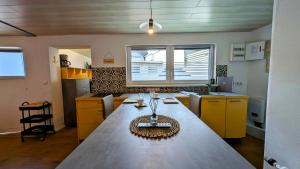 a large kitchen with a large table in the middle at De Lütte Seileree in Ahlbeck