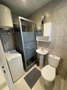 a bathroom with a toilet and a sink at Le rafale Proche aeroport et Parc Exposition in Le Bourget