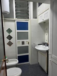 a bathroom with a toilet and a sink at Rosy home in Naples +15 photos