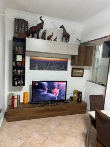 a living room with a flat screen tv on a table at Rosy home in Naples