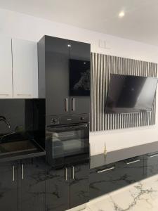 a black and white kitchen with a stove at Victory in Alicante