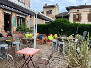 a patio with tables and chairs and tables and chairs at bdm in Montastruc-la-Conseillère