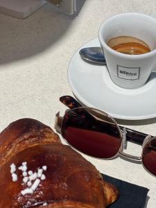 a table with a plate of bread and a cup of coffee at New Campsite in Camping Ca' Savio in Cavallino-Treporti