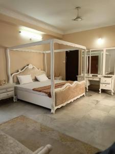 a bedroom with a canopy bed and two night stands at Luxury 9BHK AC Entire Building for families in Hyd in Hyderabad