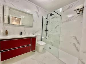 a bathroom with a shower and a toilet and a sink at Casa Lala Cudillero 1 in Cudillero