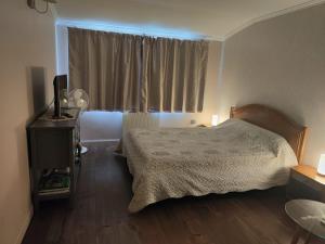 a bedroom with a bed and a television and a window at Gîte Lachevalle in Saint-Jean-dʼAngély +7 photos