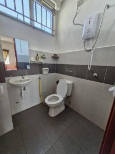a bathroom with a toilet and a sink at Anggerik Camelia Homestay Apartment Ladang Tok Pelam FREE WIFI in Kuala Terengganu +22 photos