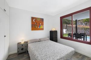 a bedroom with a bed and a window at Casa con piscina privada en Sitges in Sant Pere de Ribes +19 photos