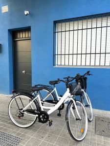 two bikes parked in front of a blue building at The Valencia Stop in Valencia