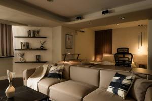 a living room with a couch and a table at Philosopher's Oasis, 30sec to ZhongXiao Dunhua MRT 哲思淨地 忠孝敦化站步行30秒 in Taipei