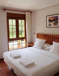 Postel nebo postele na pokoji v ubytování Hotel Pugide