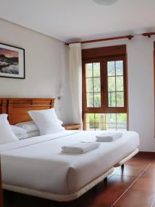 Postel nebo postele na pokoji v ubytování Hotel Pugide