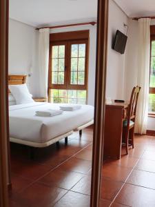 Postel nebo postele na pokoji v ubytování Hotel Pugide
