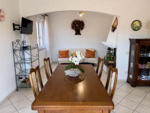 a dining room with a table and a couch at Sardinia Summer Base in Gonnostramatza