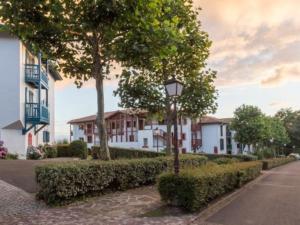 a street light in front of a row of houses at T1 Bis avec piscine vue golf et montagnes in Arcangues