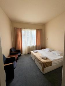 Postel nebo postele na pokoji v ubytování Blue Sevan Hotel