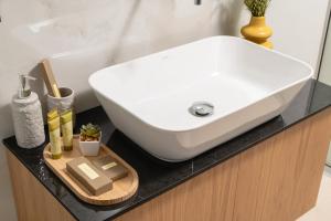 a white sink on a counter with a cutting board at Elia City Apartments in Chania Town +12 photos