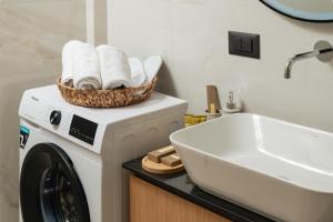 a bathroom with a washing machine and a sink at Elia City Apartments in Chania Town