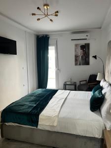 a bedroom with a large bed with a ceiling fan at Dimi Deluxe in Perea