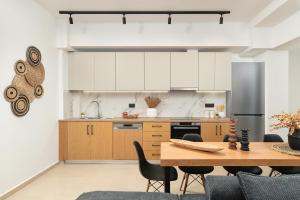 a kitchen with a wooden table and chairs at Elia City Apartments in Chania Town