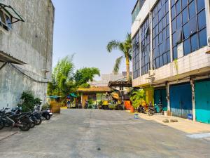a street with motorcycles parked next to a building at Themas Guest House in Jakarta