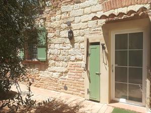 a brick building with a green door and window at Wohnung in Landhaus mit Resort-Adults only in Ottiglio +27 photos