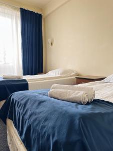 Postel nebo postele na pokoji v ubytování Blue Sevan Hotel
