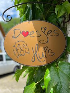 a sign that says dogs lives hanging on a tree at Appartement Doesjes Huis in Naumburg